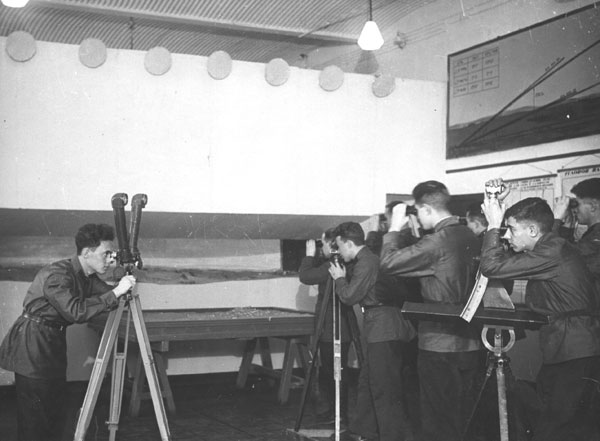 Студенты на занятиях по военной подготовке обучаются навыкам работы с оптическими приборами. 1930-ые годы.